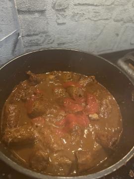 Air-fried tomato and plum mix added to the curry