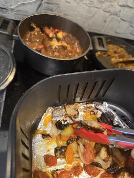 Transferring the air-fried mix into the pot