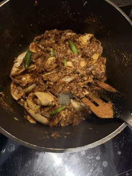 Masala frying with onion, garlic, and green chillies