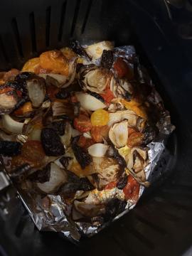 Air-fried cherry tomatoes, dried plums, and onion